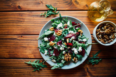 Arugula and beetroot salad with walnuts and feta cheese, top view