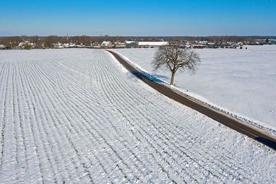 High angle view of snow covered land against sky