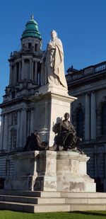 Low angle view of statue against building