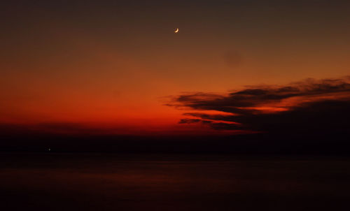 Scenic view of sea against romantic sky at sunset