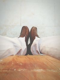 Low section of man standing on tiled floor