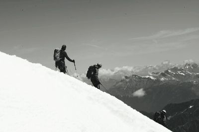 People walking on snow covered landscape