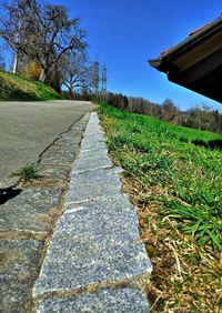 Surface level of country road against sky