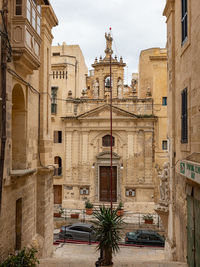 Street amidst buildings in city against sky