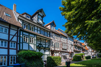 Low angle view of buildings against blue sky