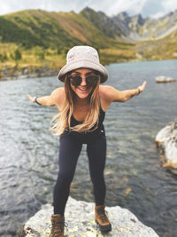 Full length portrait of woman standing in water