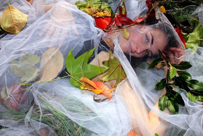 High angle portrait of bride lying on grass