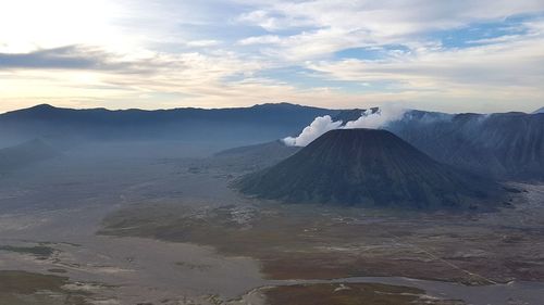 View of volcanic landscape against cloudy sky