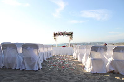 Panoramic view of people at beach against sky
