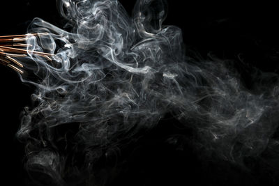 Close-up of smoke over black background