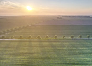 Scenic view of field against sky during sunset