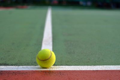 Close-up of tennis ball on line