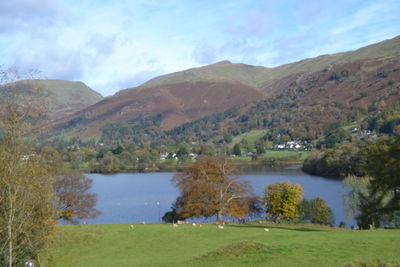 Scenic view of lake and mountains against sky