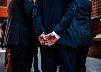 Midsection of couple standing outdoors