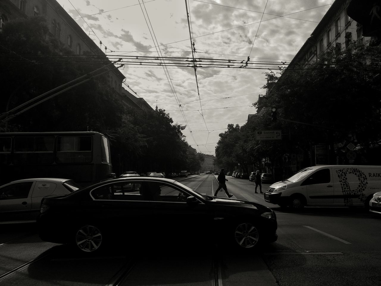 CARS ON ROAD AGAINST BUILDINGS