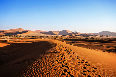 Scenic view of desert against clear sky