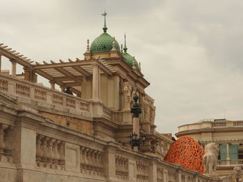 Low angle view of building against cloudy sky