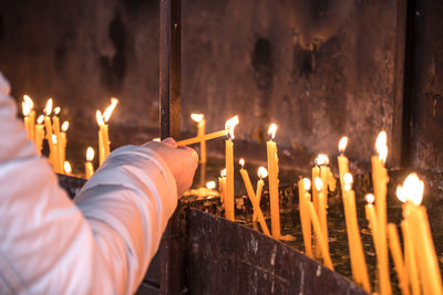 Illuminated candles burning in temple