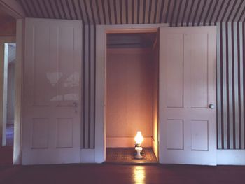 Illuminated lantern in doorway at home