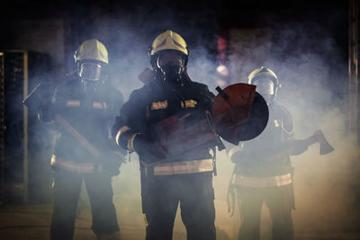 People holding equipment while standing on land