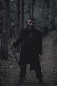 Man wearing mask in forest