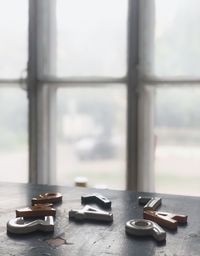 Metallic alphabets and numbers on table against window