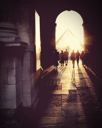 Silhouette of people walking in city