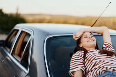 Low angle view of woman holding car