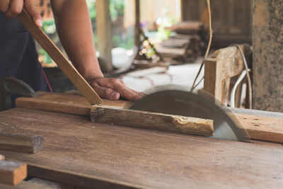 Cropped hand of man working on table