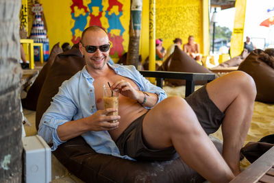 Full length of man sitting at restaurant