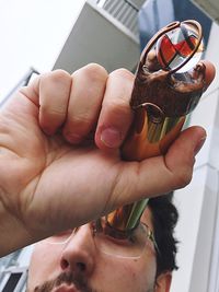 Man looking in kaleidoscope with murano glass sphere