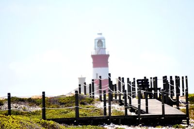Lighthouse on building against sky
