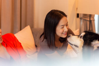 Young woman with cat at home