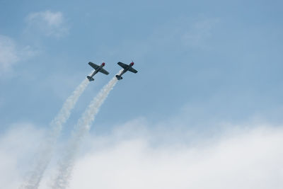 Low angle view of airshow against sky