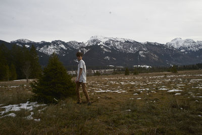 Man standing on field in forest