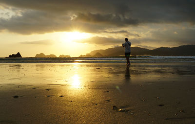 Amazing sunset at pulau merah beach in banyuwangi, east java, indonesia.