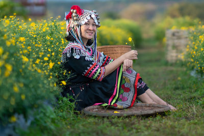 Full length of woman wearing hat while standing on field