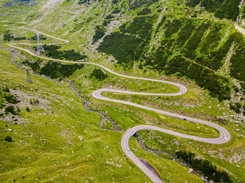 High angle view of winding road amidst trees