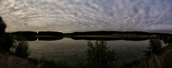 Scenic view of lake against sky at sunset