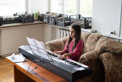 Portrait of woman using laptop at home