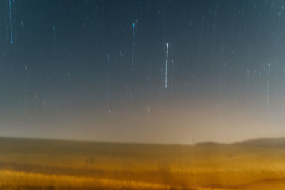 Scenic view of landscape against sky at night