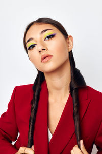 Portrait of young woman against white background