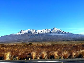 Scenic view of snowcapped mountains against clear blue sky