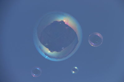 Close-up of bubbles against blue background