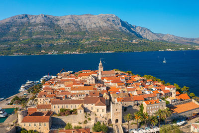 High angle view of townscape by sea