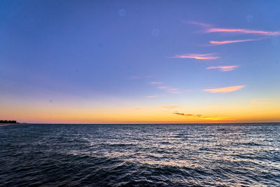 Scenic view of sea against clear sky during sunset