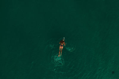 High angle view of man swimming in sea