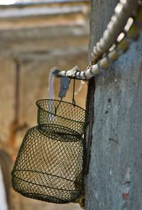 Close-up of rusty chain hanging on metal fence
