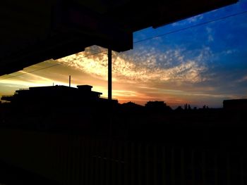 Silhouette of building at sunset