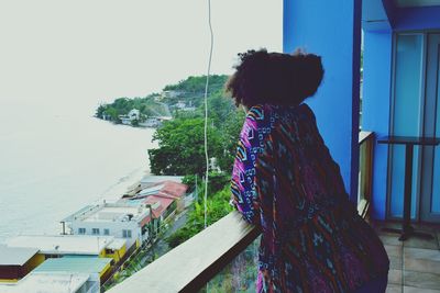 Side view of girl standing in balcony